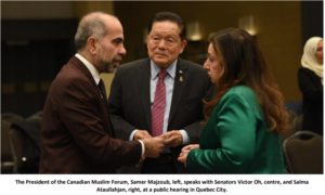 The President of the Canadian Muslim Forum, Samer Majzoub, left, speaks with Senators Victor Oh, centre, and Salma Ataullahjan, right, at a public hearing in Quebec City.